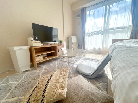 スマートステイ北円山の室内写真、シングルベッド、座椅子とローテーブル、薄型テレビ